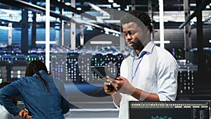 Data center technician using tablet to do node tree programming