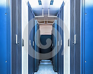 Data centre interior with server racks of hardware equipment performing functions of processing, storing and distributing