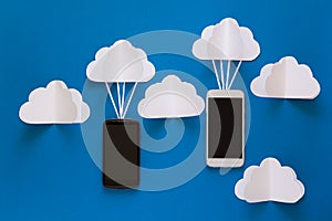 Data communications and cloud computing network concept. Smart phone flying on paper cloud.