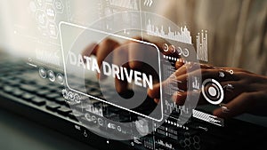 Data Driven Technology Concept with Hands Typing on Keyboard and Digital Interface Displaying Statistics and Graphics