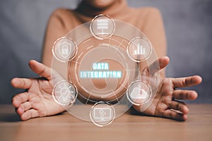 Person hand holding data integration icon on virtual screen