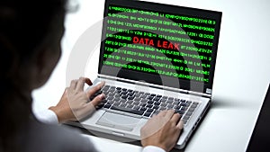 Data leak on laptop computer, woman working in office, cybercrime, close up