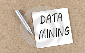 DATA MINING text on sticky note on a cork board with pencil