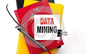 DATA MINING text written on a sticky on colorful notebooks