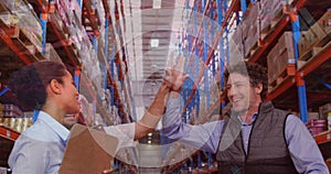 Data processing over diverse male and female supervisors high fiving each other at warehouse photo