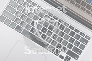 Data protecting security concept. Computer Internet protection symbol on blured keyboard background. Hacker attack and