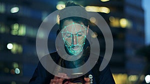 Data protection concept. Man scanning the face by smart phone.