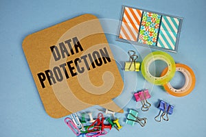 Data Protection text with stationery on blue background
