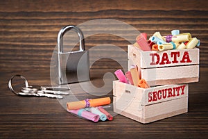 DATA and SECURITY concept. Colored papr scrolls in wooden boxes on dark wooden background