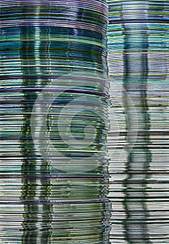 Data storage abstract background showing layered stacks of translucent metallic DVD and CD computer storage disks