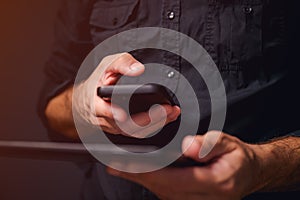 Data synchronization, man using smartphone and digital tablet computer to sync data