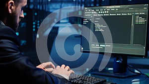 Database admin checking mainframe system on computer