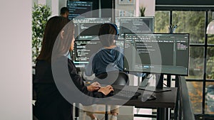 Database developer using computer to write code on terminal window