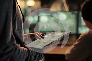 Database illegal access, hacker using spyware on digital tablet
