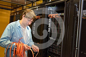 Datacenter engineer rolling up network cables