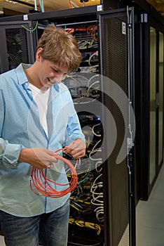 Datacenter specialist working with optical cable