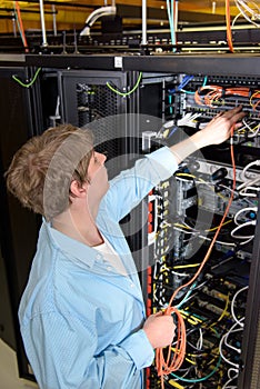 Datacenter technician patching optical cable