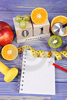 Date of 1 January, fruits, dumbbells and tape measure, new years resolutions