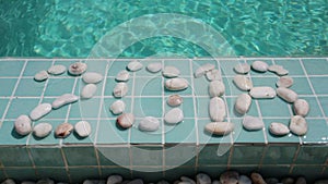 Date 2018 is laid out by pebble stones on the edge of the pool in the tropical resort