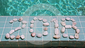 Date 2018 is laid out by pebble stones on the edge of the pool in the tropical resort