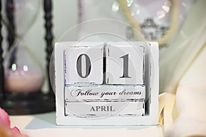 Date April 1 on wooden calendar with bokeh in the background photo