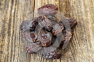 Date fruit on wood background. Organic and fresh nuts.