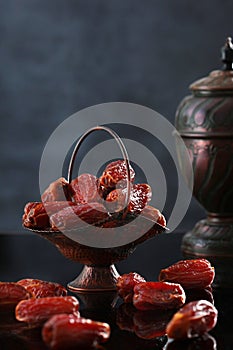 Date fruits in an ancient dish. Dates are a Ramadan dish. Food in Ramadan.