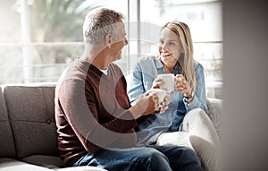 Date night done from the comfort of home. a mature couple enjoying a relaxing coffee break on the sofa together at home.