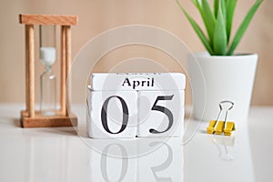 Date on white wooden cubes - the fifth, 05 April on a white table