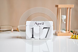 Date on white wooden cubes - the seventeenth, 17 April on a white table