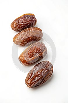 Dates arranged in a white bowl