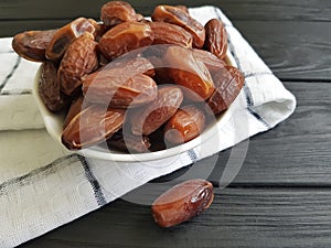 Dates on a black wooden east food snack healthy ingredient heap nutrition