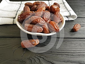 Dates on a black wooden towel food healthy ingredient heap nutrition