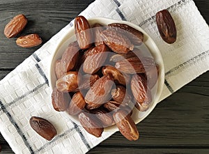 dates on a black wooden towel healthy heap