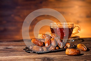 Dates and cup of tea, concept of muslim feast holy month Ramadan Kareem, copy space