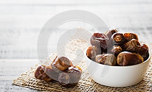 Dates fruit on dark wooden background. Muslim simple Iftar concept. Ramadan food and drinks