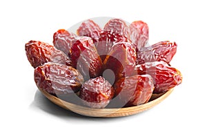 Dates fruit. Date fruits in wooden bowl isolated on white background. Heap of Organic Medjool dates