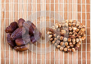 Dates and muslim prayer beads on matting