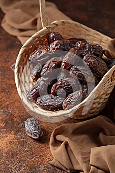 Dates in a old basket on a brown background