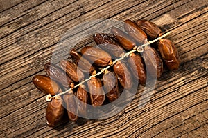 Dates tropical fruit branch on old wooden