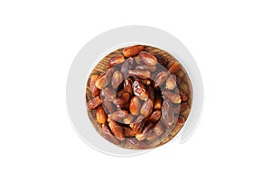 Dates in a wooden plate isolated on white background. Dried fruits. Natural healthy food. View from above