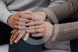 Dating agency. Couple holding hands together, closeup view