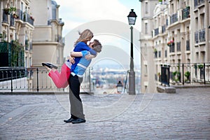 Dating couple on Montmartre, girl is jumping