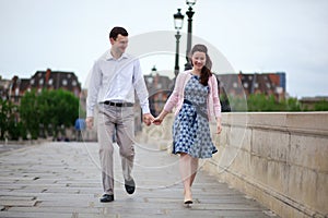 Dating couple in Paris walking hand in hand