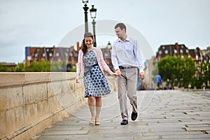 Dating couple in Paris walking hand in hand