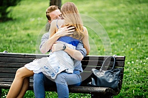 Dating couple sitting on bench