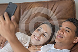 Dating and relationship. Young couple interracial black boy and caucasian girl enjoying time at home in indoor leisure activity