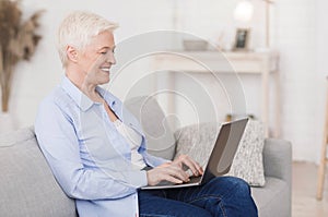 Dating Sites For Seniors. Portrait of elderly lady with laptop at home