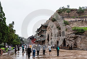 Tourists and caves at Datong Yungang Grottoes