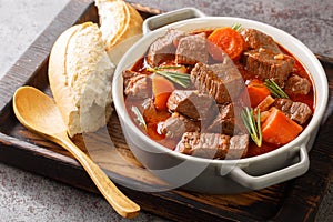 Daube de Boeuf Provencale slow cooked Rich Beef Stew closeup in the wooden tray. Horizontal